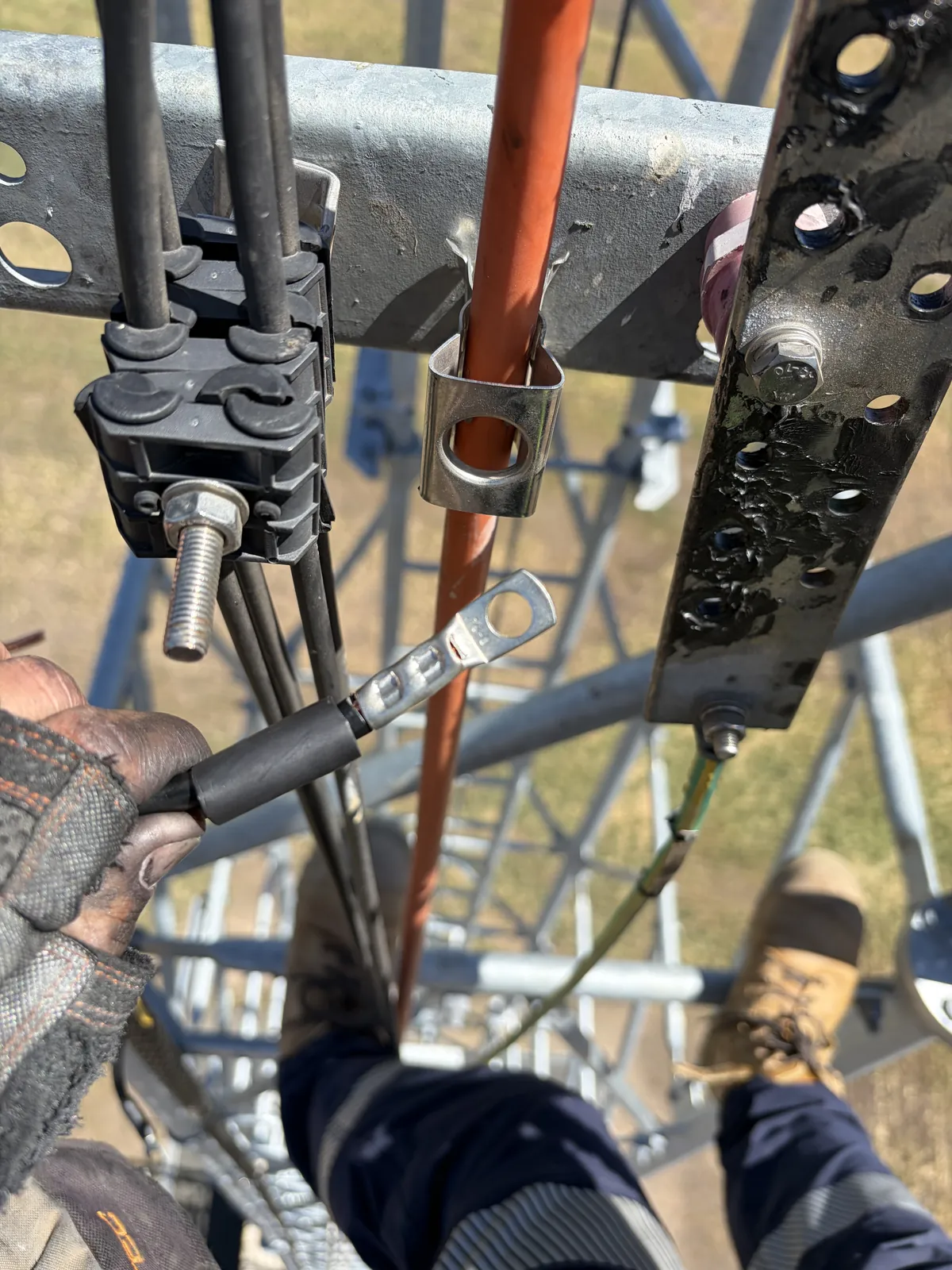 Feeder earth lug being fitted to a tower earth bar