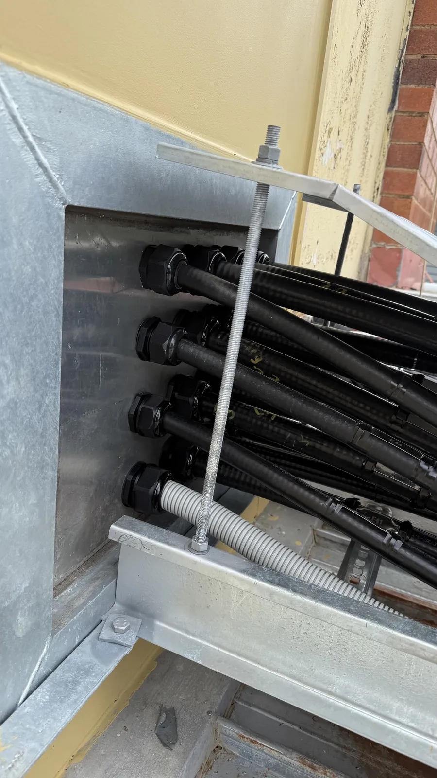 Cable glands through an equipment shelter entry plate